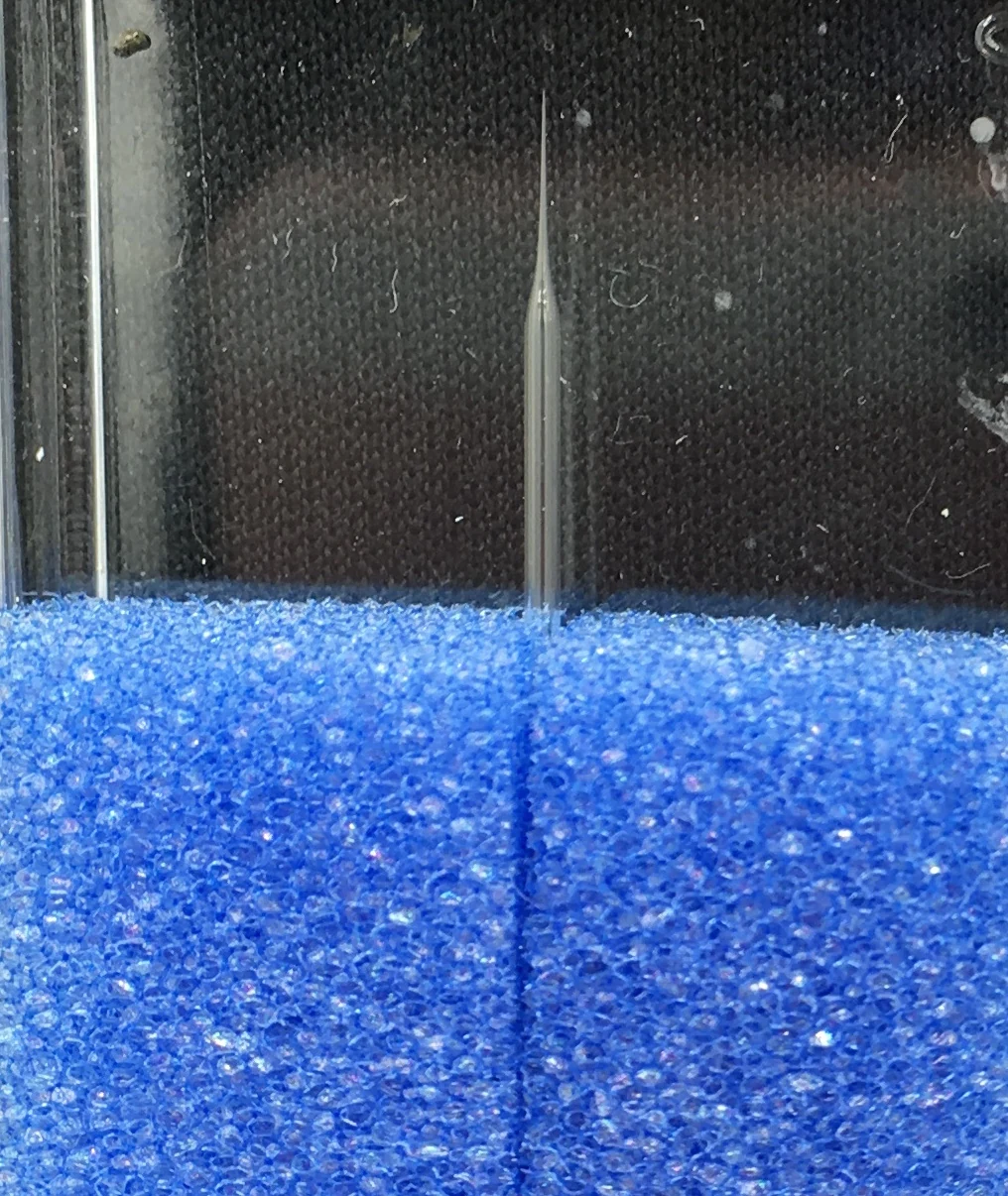 Micron-scale glass needles